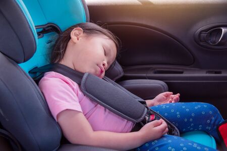 Girl sleeping in car seatの写真素材