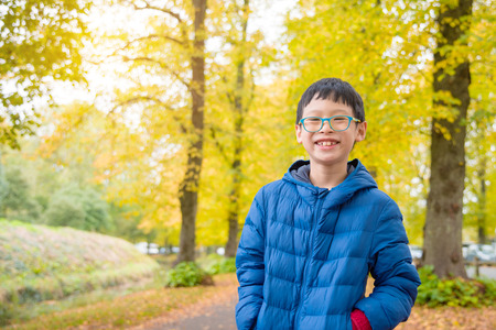 Boy in autumn parkの写真素材