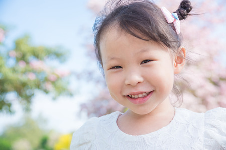 Little asian girl smiling in parkの写真素材