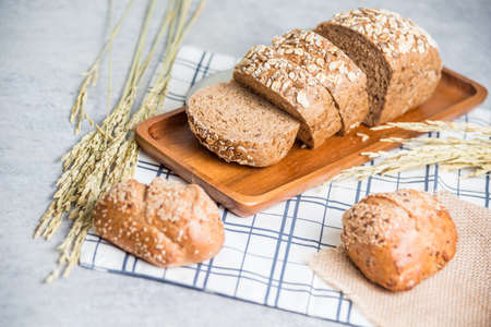 Homemade bread and wheat on table at kitchenの写真素材