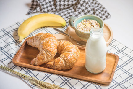 Cereal,bread ,milk and banana on tableの写真素材