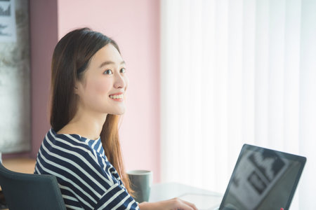 Beautiful asian woman smiling in officeの写真素材