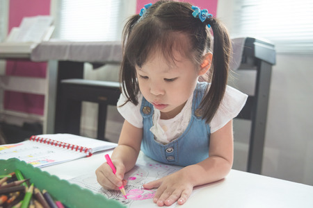 Little asian girl painting pictureの写真素材