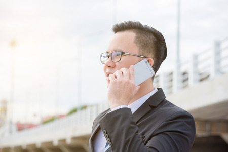 Businessman talking with someone via mobile phoneの写真素材