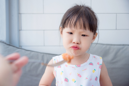 Little asian girl refuse to eat foodの写真素材