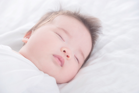 Little baby sleeping on bedの写真素材