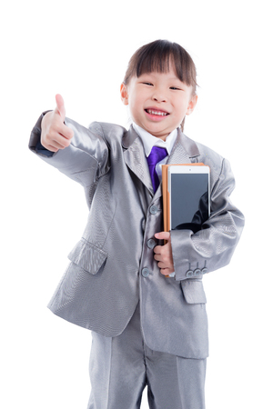 little girl in suit smiling over white backgroundの写真素材