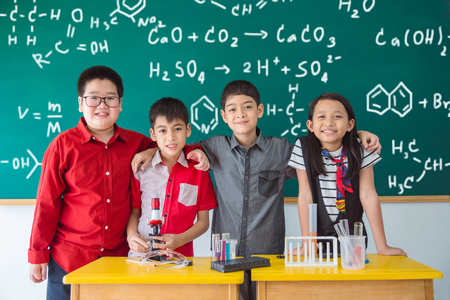 Group of Asian student standing and smile in front of chalkboardの写真素材