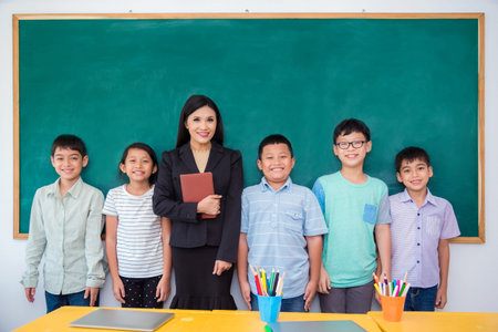 Group of happy asian student and teacher standing in classroom