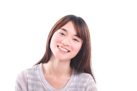 Beautiful young asian girl smiling over white backgroundの写真素材