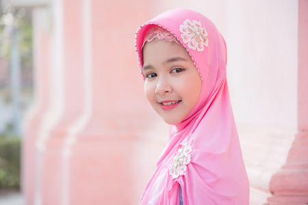 Pretty muslim girl is looking at camera and smiles.の写真素材