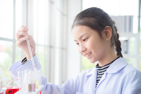 Young asian school girl doing chemistry experiment in laboratory classroom. Education concept.の写真素材