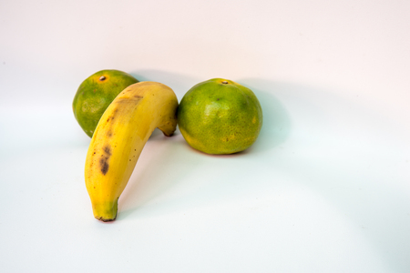 fruits isolated banana and orange in penis shape on a white backgroundの写真素材