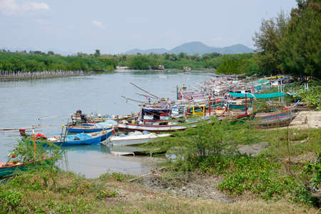 Small fishing boat In the river that flows out to the sea Prachuap Khiri Khan Province  Thailandの写真素材