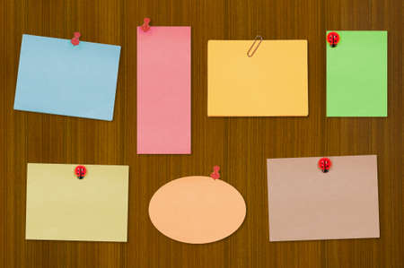 Colored notes on old wooden boardの写真素材