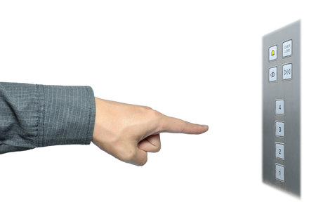 businessman hand to press button on lift
