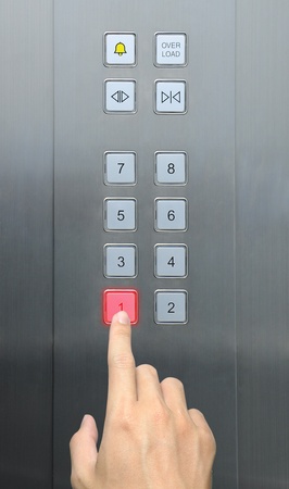 businessman hand press 1 floor in elevatorの写真素材