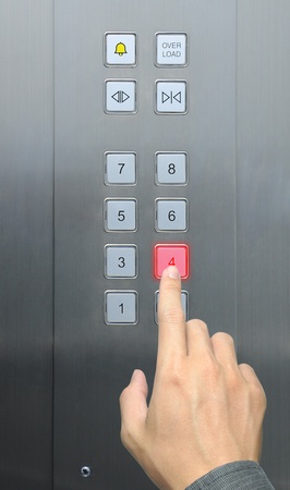 businessman hand press 4 floor in elevatorの写真素材