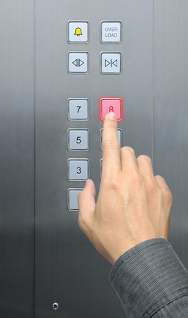 businessman hand press 8 floor in elevatorの写真素材