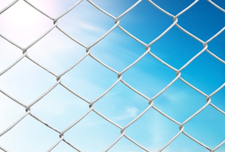 chain link fence see blue skyの写真素材