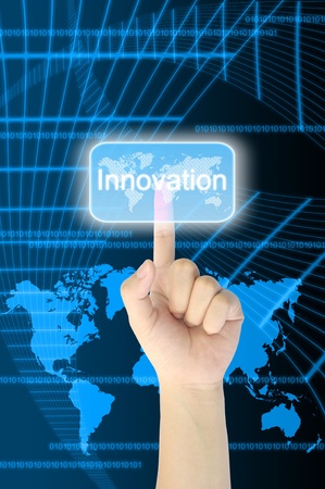 hand pressing innovation button on a touch screen interface の写真素材