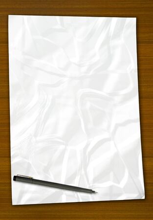 white blank note paper and pen on wood backgroundの写真素材