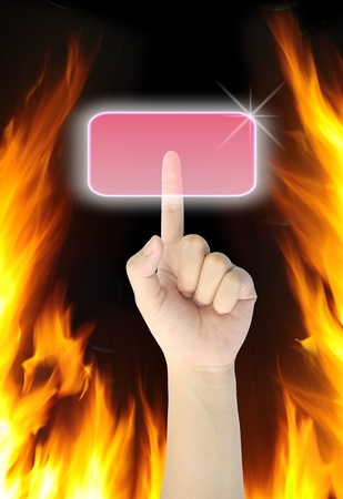 hand pressing button on fire background の写真素材