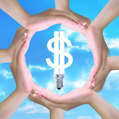 light bulb model of a dollar symbol in human hands making a circleの写真素材