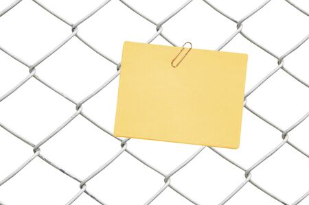 yellow note on chain link fenceの写真素材