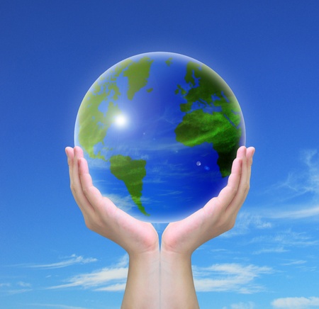 world and women hand holding on blue skyの写真素材