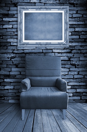 old single sofa seat and frame in front of the wallの写真素材