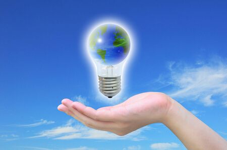 the world in light bulb on women handの写真素材