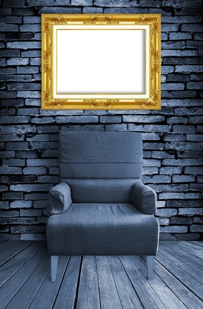 old single sofa seat and frame in front of the wallの写真素材