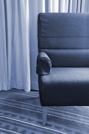 old single sofa seat in front of a curtainの写真素材