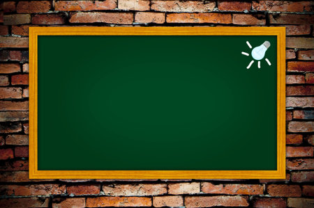 light bulb on green blackboardの写真素材