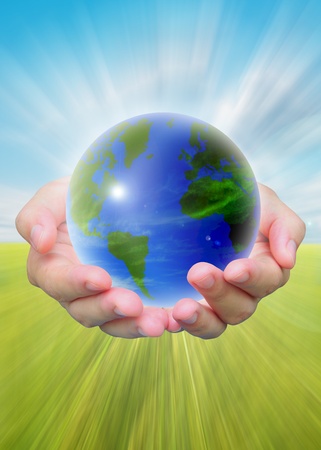 world and women hand holding on blue skyの写真素材