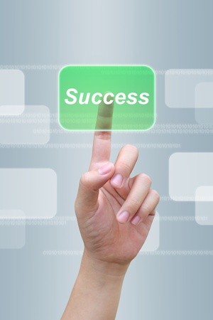 hand pushing success button on a touch screen interface の写真素材