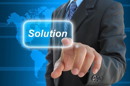 businessman hand pushing solution button on a touch screen interface businessman hand pushing solution button on a touch screen interface