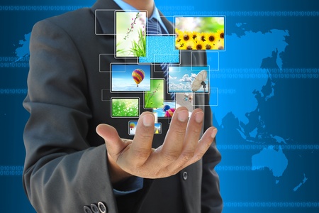 businessman hand holding streaming images virtual buttonsの写真素材