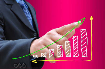 businessman hand pushing a business graph on a touch screen interfaceの写真素材