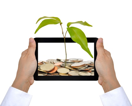 the tree and coin on touch pad PCの写真素材