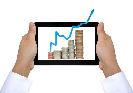 coin and business graph on touch pad PCの写真素材