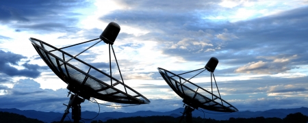 satellite dish antennas under blue skyの写真素材