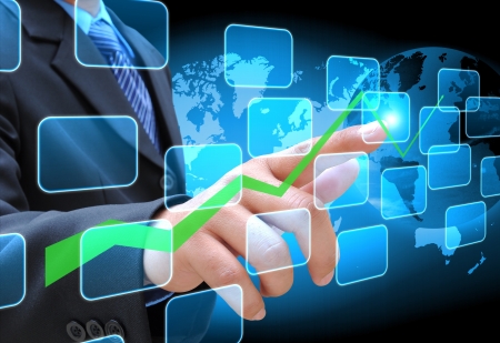 businessman hand pushing a business graph on a touch screen interfaceの写真素材