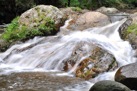flowing waterfall in the jungle of Thailandの写真素材