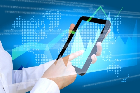 hand pushing a business graph on a touch screen interfaceの写真素材