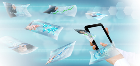 hand pushing a button streaming images on a touch screen interfaceの写真素材