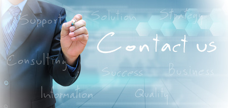 businessman hand writing contact usの写真素材