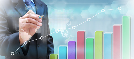 businessman hand writing a business graph on a touch screen interfaceの写真素材