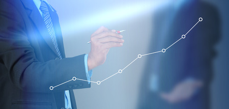 A businessman hand writing a business graphの写真素材